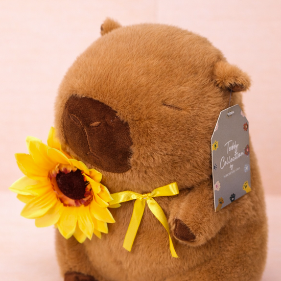 PELUCHE CAPIBARA CON GIRASOL
